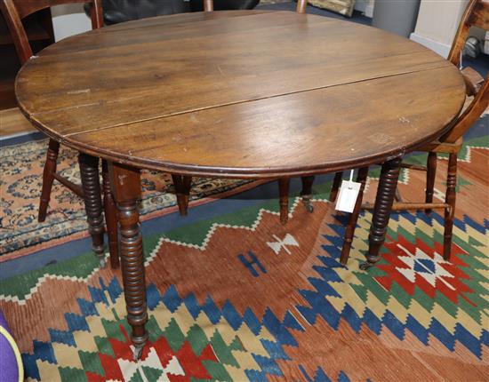 A 19th century French walnut circular drop leaf dining table 115cm diameter